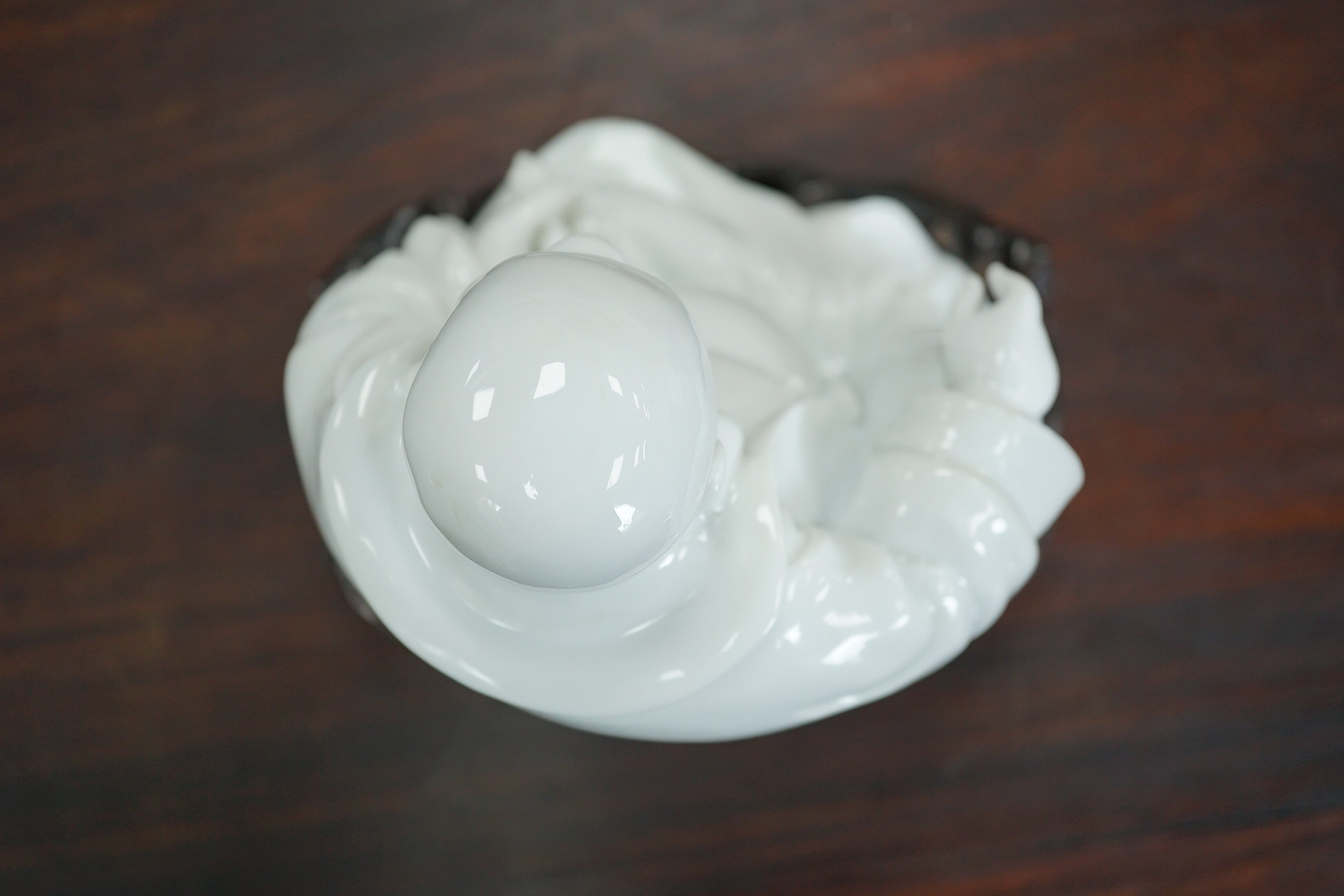 A Chinese blanc-de-chine seated figure of Budai, 18th/19th century